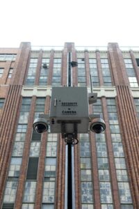Security cameras in front of a classic New York City building, capturing urban safety.