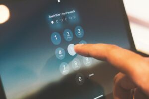 Close-up of a finger entering a passcode on a smartphone security screen for Multifactor