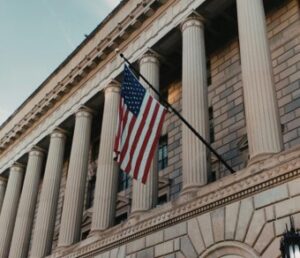 A majestic neoclassical building with the US flag, showcasing Washington DC's architectural heritage.